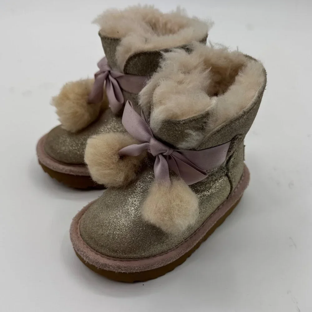 UGG Infant Girls Metallic Gold Sheepskin Bow Booties With Pom-Poms - Picture 1 of 11